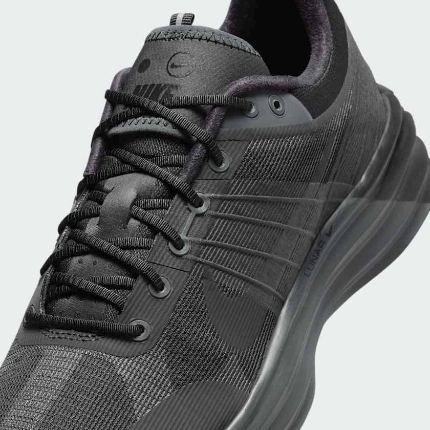 Close-up zoom on the front of the Nike Lunar Roam Men's trainers, showing the breathable textile upper texture, Magwire details, and lacing system.