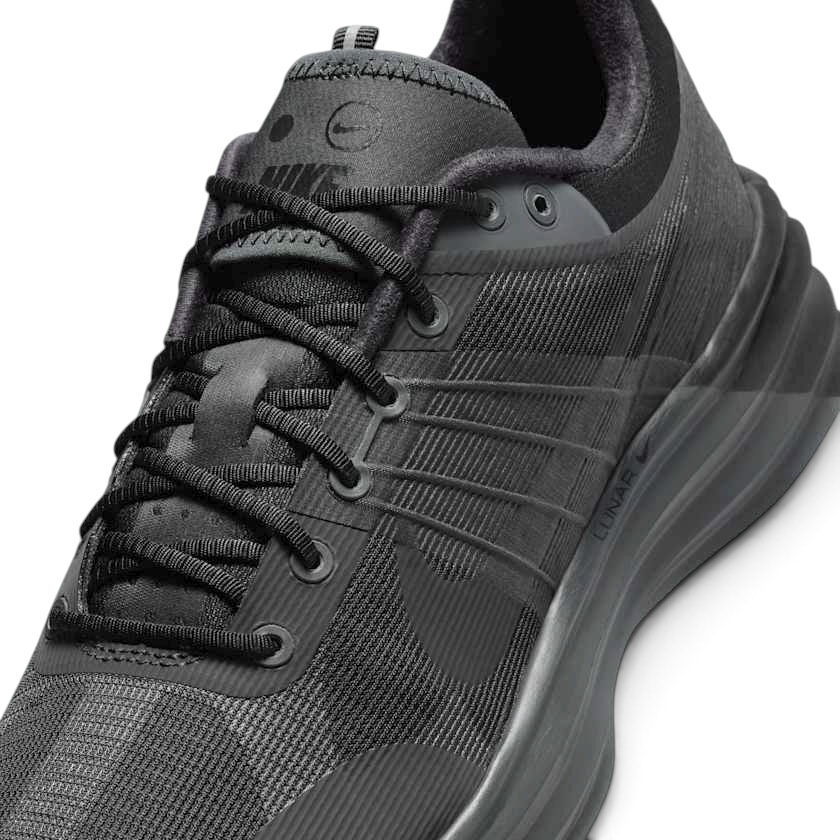 Close-up zoom on the front of the Nike Lunar Roam Men's trainers, showing the breathable textile upper texture, Magwire details, and lacing system.