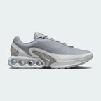 Nike Air Max DN Men's running shoes in grey, side profile showing visible Dynamic Air unit in the heel, textured upper, and sleek silhouette.