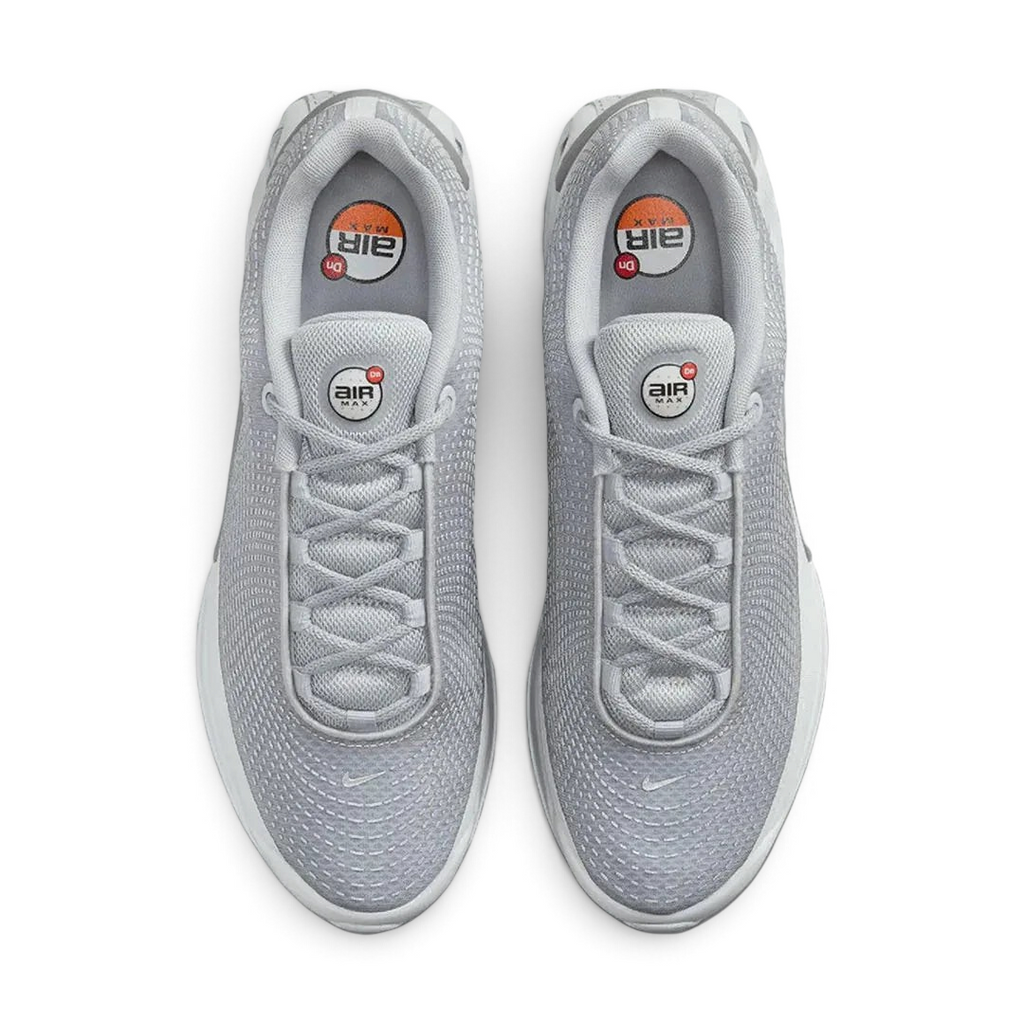 Top-down view of a pair of Nike Air Max DN Men's running shoes in grey, highlighting their futuristic design and lace-up closure.