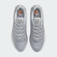 Top-down view of a pair of Nike Air Max DN Men's running shoes in grey, highlighting their futuristic design and lace-up closure.