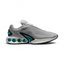 Nike Air Max DN Men's running shoes in light smoke grey and black, side profile showing visible Dynamic Air unit in the heel, textured upper, and sleek silhouette.
