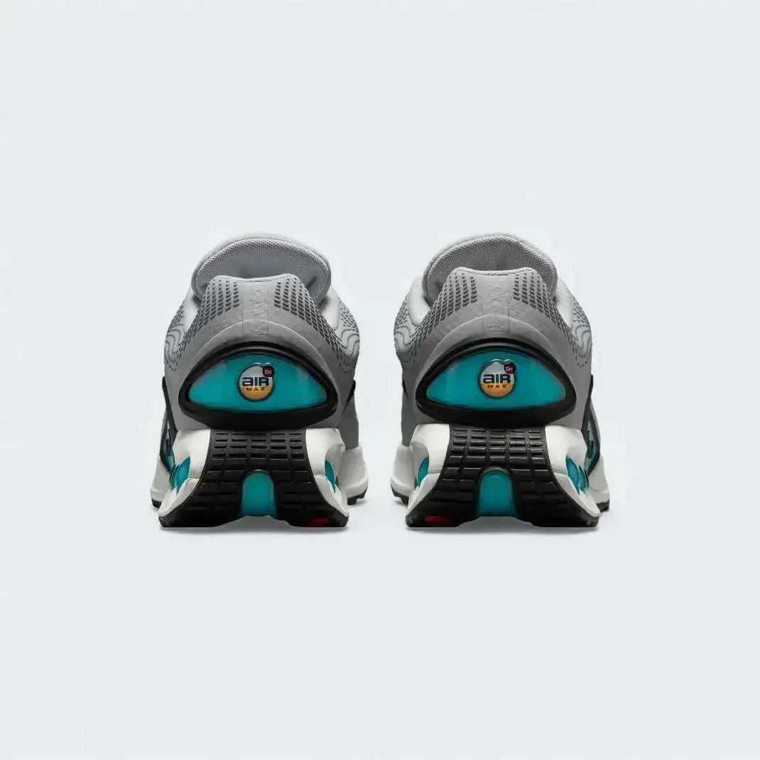 Rear view of the Nike Air Max DN Men's grey running shoes, focusing on the visible Dynamic Air unit in the heel and molded heel counter.