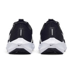 Focuses on the rear profile, displaying the seamless black engineered mesh heel counters, vertical reflective safety bars, micro-Swooshes on the midsole bevel, and the wide flared base of the React foam platform.