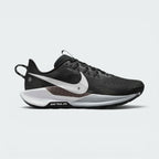 Highlights the outer profile of the shoe, featuring a crisp white Nike Swoosh sweeping across the black engineered mesh upper, an underlaid cross-hatch graphic panel, a grey and white ReactX foam midsole, and the debossed "NIKE TRAIL ATC" badge on the black outsole frame.