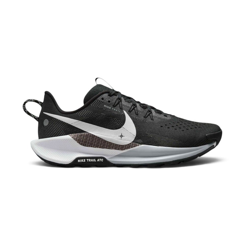 Highlights the outer profile of the shoe, featuring a crisp white Nike Swoosh sweeping across the black engineered mesh upper, an underlaid cross-hatch graphic panel, a grey and white ReactX foam midsole, and the debossed "NIKE TRAIL ATC" badge on the black outsole frame. Main image