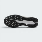 Displays the full-length black Nike Trail All-Terrain Compound (ATC) rubber sole, showcasing the multi-directional lug arrangement, flex grooves, and the central white stability shank stamped with "NIKE TRAIL" branding.