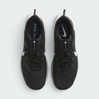Focuses on the symmetrical lacing structure and top view of both shoes, displaying the black mesh tongues with "PEGASUS TRAIL 5" branding tags, black laces integrated with Flywire cables, and black insoles printed with white Nike trail logos.