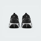 Focuses on the rear view of both heels, highlighting the speckled black-and-white pull loops, reflective circular safety dots, contoured ankle collars, and the split rear tread design of the black ATC outsole.