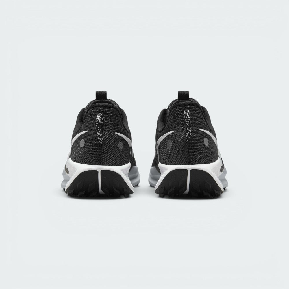 Focuses on the rear view of both heels, highlighting the speckled black-and-white pull loops, reflective circular safety dots, contoured ankle collars, and the split rear tread design of the black ATC outsole.