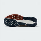 Displays the full-length Nike Trail All-Terrain Compound (ATC) rubber sole split between dark navy and rust-red tread sections, showcasing the multi-directional lug grid and central white shank with trail logo.