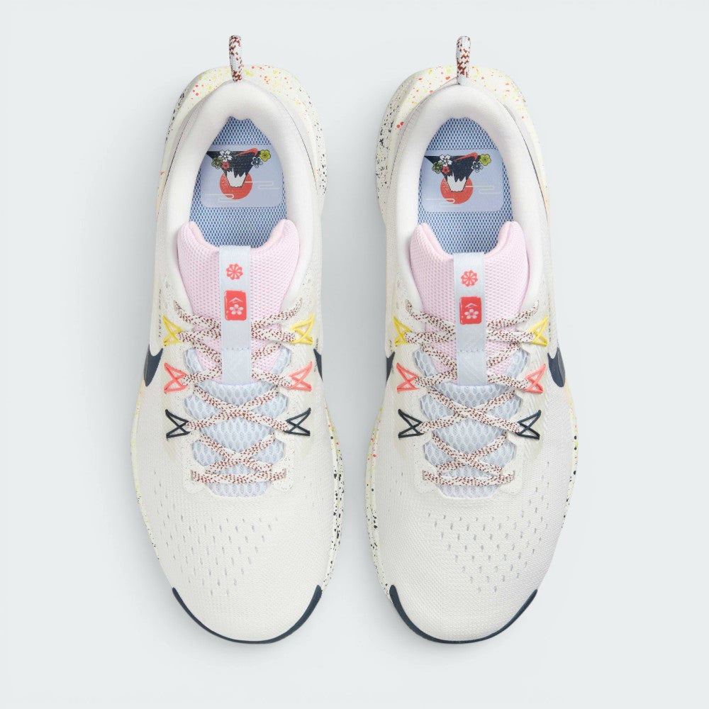 Focuses on the locked-in lacing layout, displaying the Pink Foam mesh tongues, patterned flecked laces, yellow, pink, and navy Flywire eyelet cables, and insoles printed with Mount Fuji sunrise graphics.