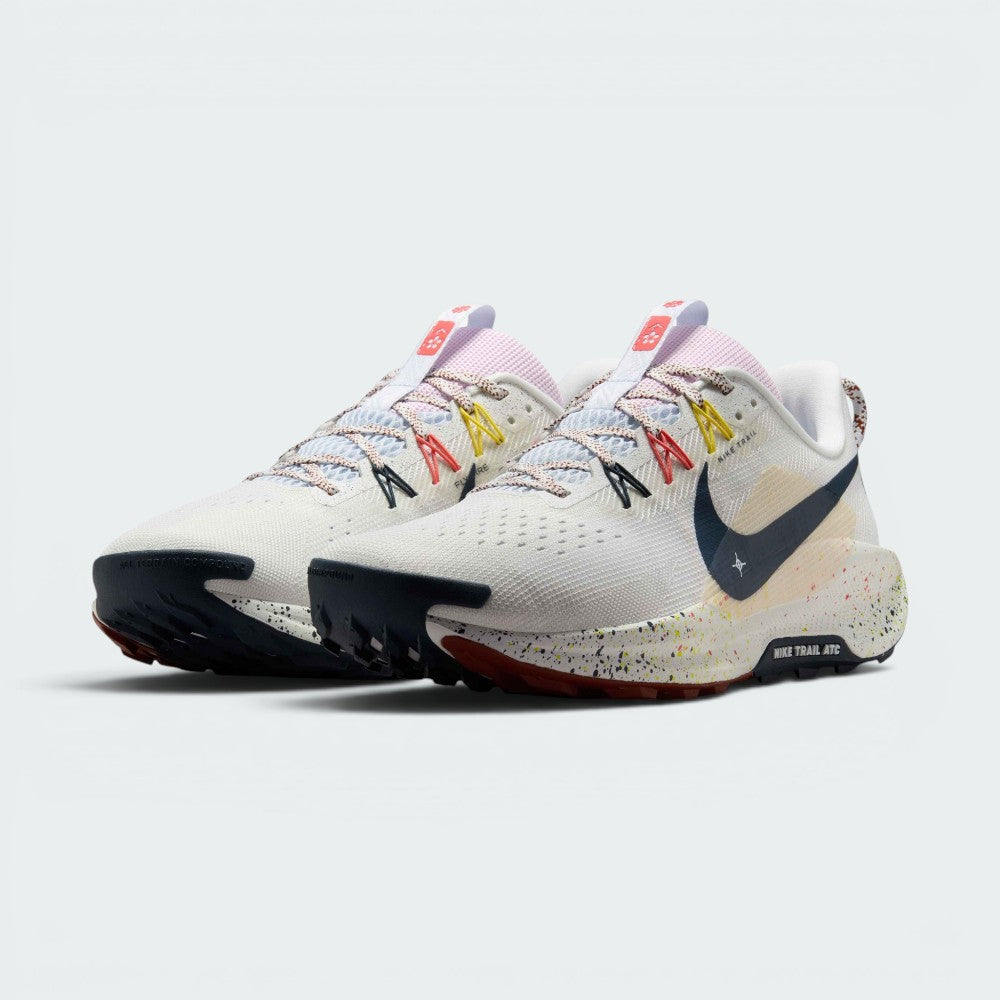Emphasising the low-cut, aggressive off-road stance of the trainers and the professional colour harmony of the white uppers sitting cleanly above the paint-splattered ReactX foam midsoles.