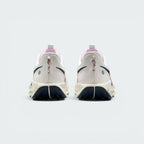 Focuses on the rear profile, highlighting the flecked pull loops, circular reflective dots on the heel counters, pink tongue collars, and the wide footprint of the splattered ReactX midsole base.