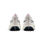 Focuses on the rear profile, highlighting the flecked pull loops, circular reflective dots on the heel counters, pink tongue collars, and the wide footprint of the splattered ReactX midsole base.