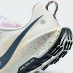 Highlights the "unreal" clean finish where the paint-splattered ReactX foam midsole meets the dark navy ATC rubber tread, showing the debossed "NIKE TRAIL ATC" outsole frame.