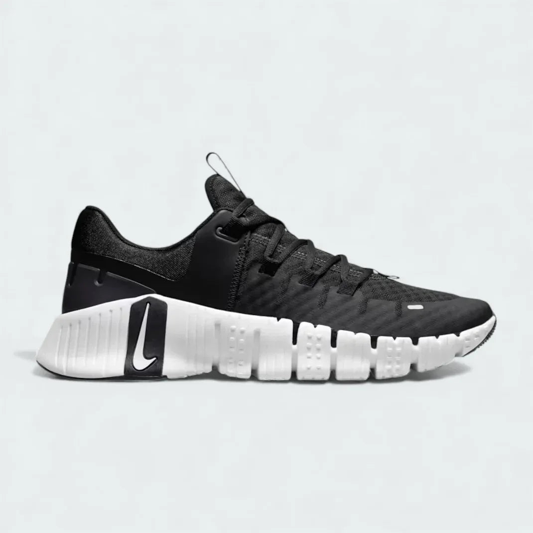 Nike Free Metcon 5 Men's training shoes in black and anthracite grey with white accents, side profile showing mesh upper, flexible forefoot, and stable heel. Main image