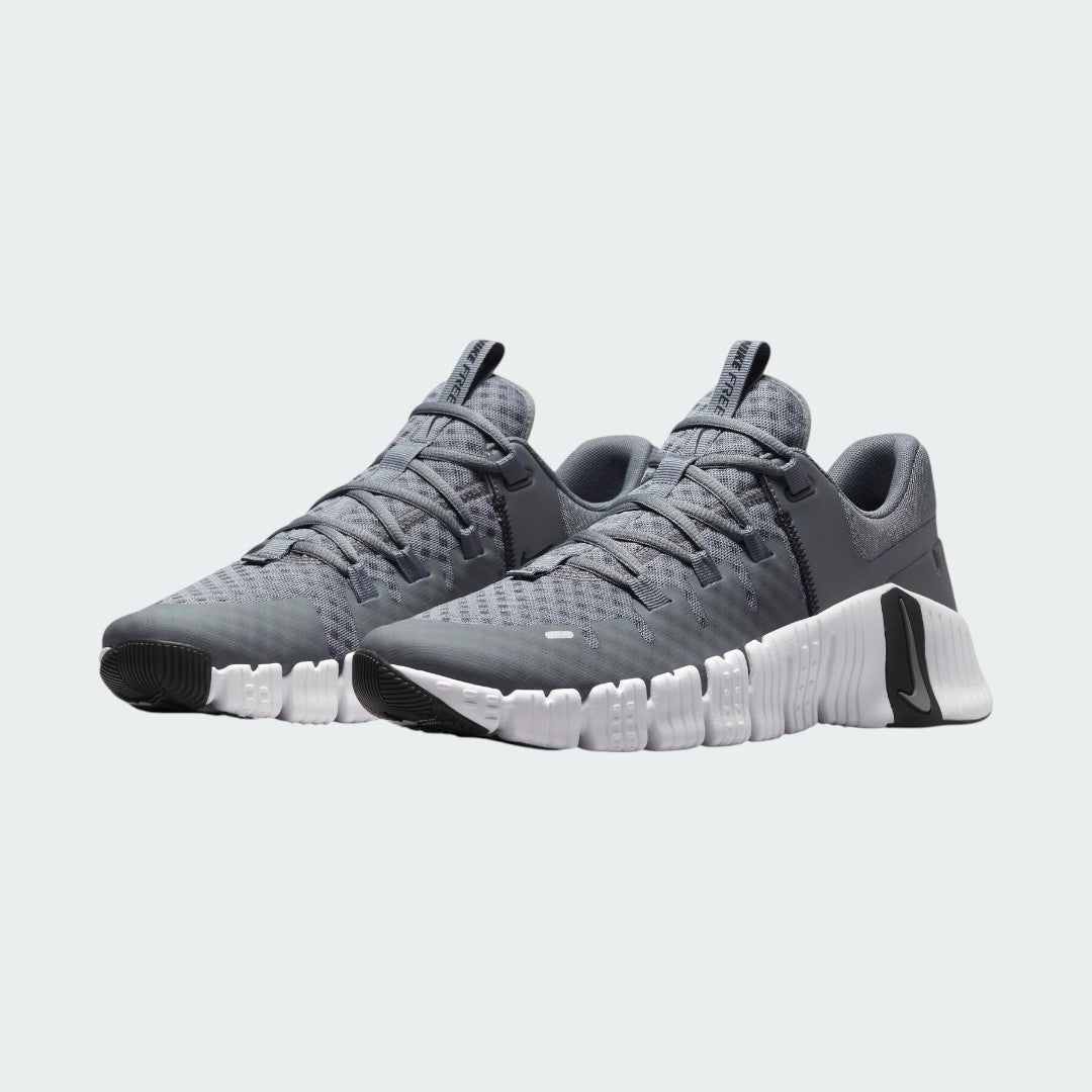Angled view of two Nike Free Metcon 5 Men's grey training shoes, side by side, showcasing their dynamic design and supportive structure.