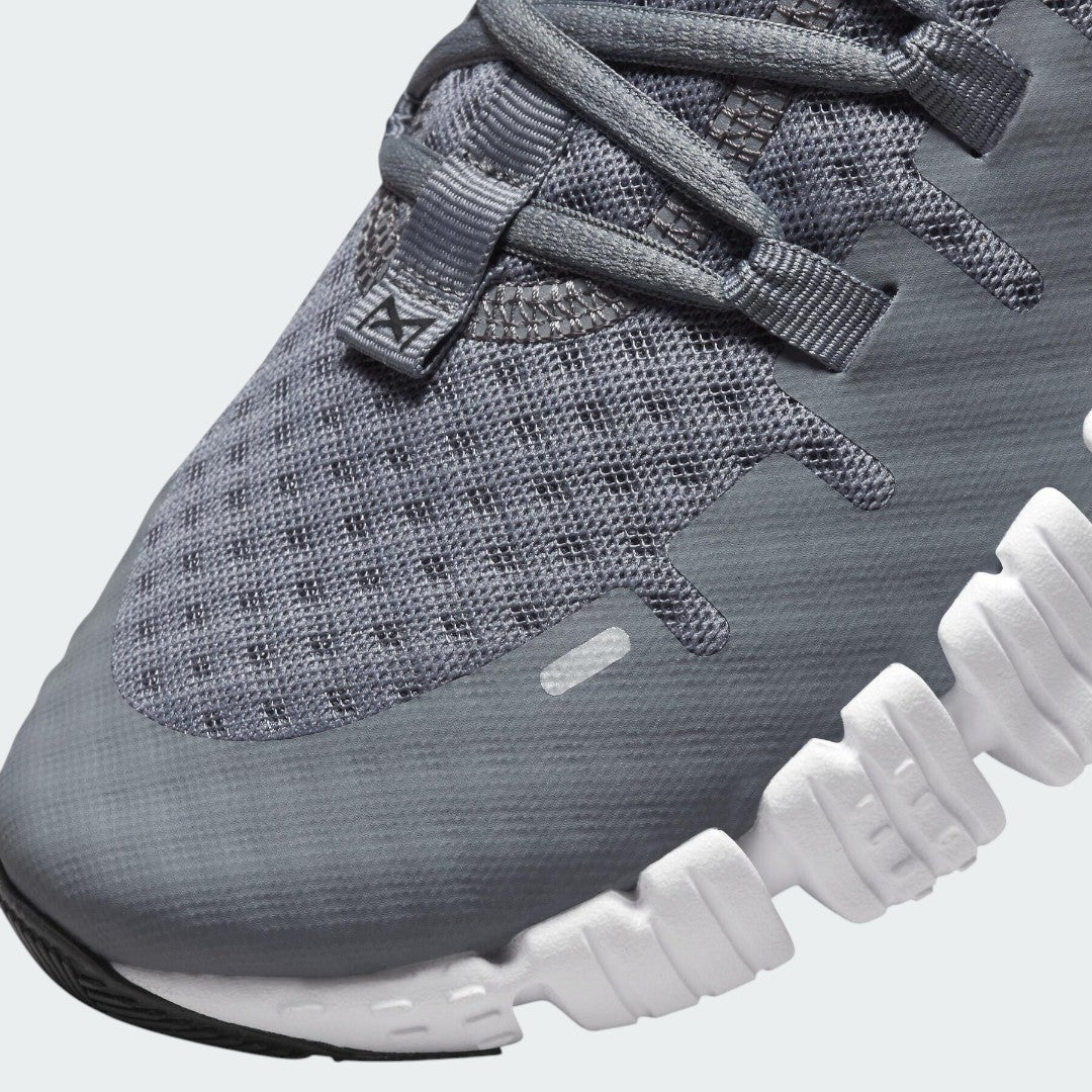 Close-up zoom on the front of the Nike Free Metcon 5 Men's grey training shoes, showing the breathable mesh upper texture, lacing system, and flexible toe area.