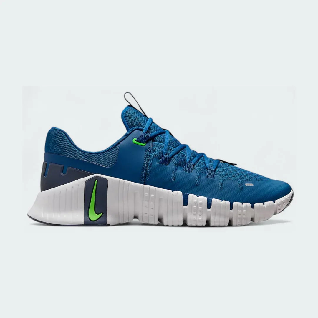 Nike Free Metcon 5 Men's training shoes in blue with white accents, side profile showing mesh upper, flexible forefoot, and stable heel. Main image