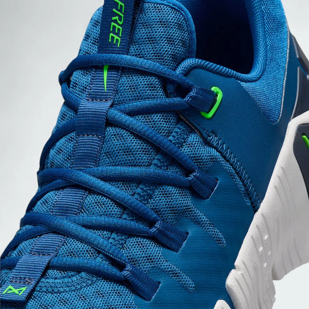 Close-up zoom on the front of the Nike Free Metcon 5 Men's blue training shoes, showing the breathable mesh upper texture, lacing system, and flexible toe area.