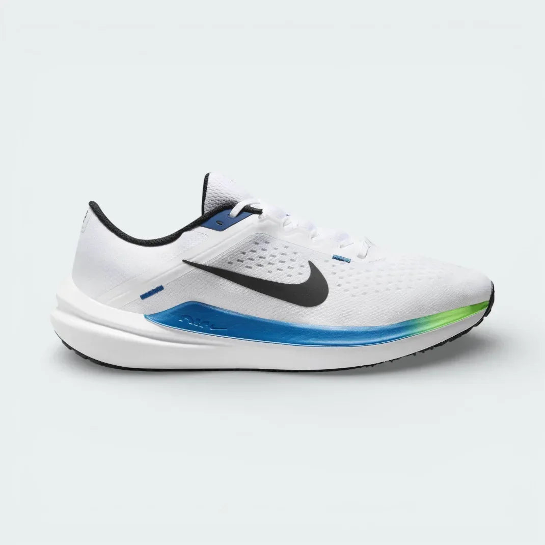 Nike Air Winflo 10 Men's trainers in white, side profile showing the bold black Swoosh, Star Blue midsole accents, and breathable mesh upper. Main image