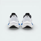 Rear view of the white trainers focusing on the structured heel support and the Star Blue detailing along the collar.