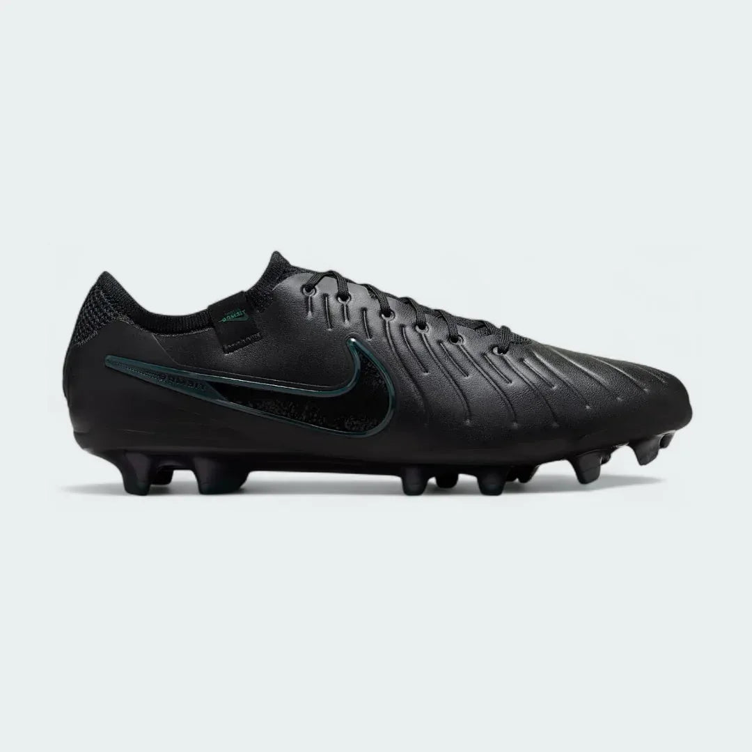 Nike Legend 10 Elite FG men's football boots in black with a deep jungle green Swoosh, side profile showing the FlyTouch Plus upper and firm ground studs. Main image
