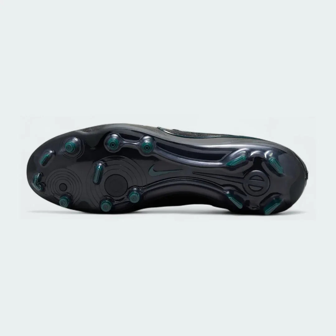 View of the outsole of the Nike Legend 10 Elite FG men's boots, showing the mix of conical and bladed studs for firm ground traction.
