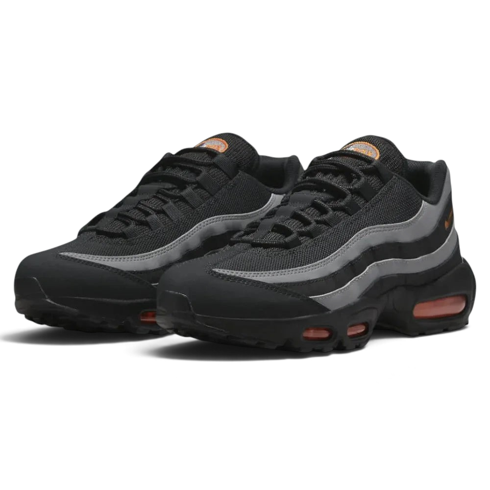 Angled view of two Nike Air Max 95 Men's black running shoes, side by side, showcasing their timeless design and layered upper.