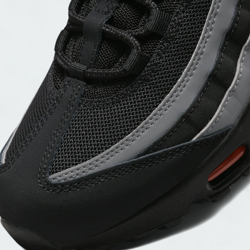 Close-up zoom on the front of the Nike Air Max 95 Men's running shoes, showing the intricate lacing system, mesh tongue, and layered overlays.