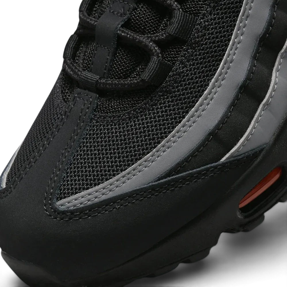 Close-up zoom on the front of the Nike Air Max 95 Men's running shoes, showing the intricate lacing system, mesh tongue, and layered overlays.