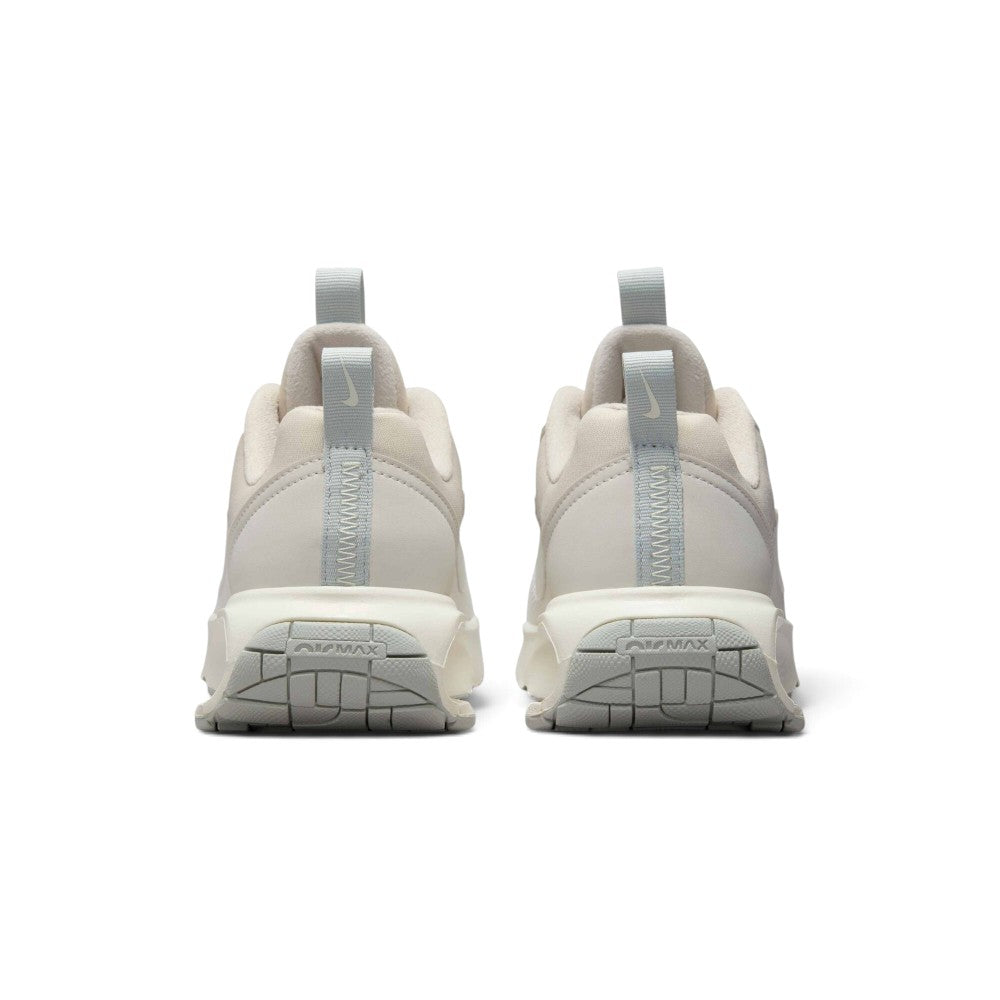 Showing the structured rear heel counter construction, detailing the synthetic heel wrap, integrated webbing pull tab, subtle branding, and visible Air bubble chamber.
