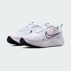 Angled view of two Nike Downshifter 12 Premium Women's white training shoes, side by side, showcasing their versatile design and cushioned profile.