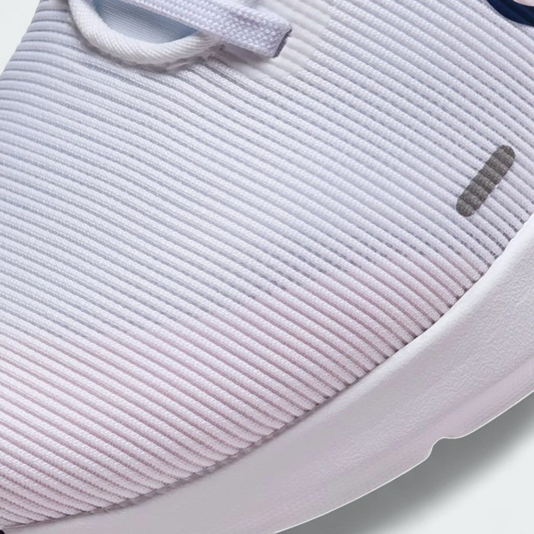 Close-up zoom on the front of the Nike Downshifter 12 Premium Women's white training shoes, showing the mesh upper texture, lacing system, and supportive midfoot band.