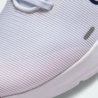 Close-up zoom on the front of the Nike Downshifter 12 Premium Women's white training shoes, showing the mesh upper texture, lacing system, and supportive midfoot band.
