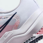 Detailed zoom on the outsole and midsole of the Nike Downshifter 12 Premium Women's white training shoes, highlighting the soft foam cushioning and durable rubber outsole.