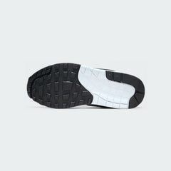 View of the outsole of the Nike Air Max 1 Women's white trainers, showing the durable rubber waffle tread pattern for traction.