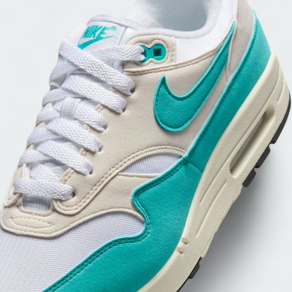 Close-up zoom on the front of the Nike Air Max 1 Women's trainers, showing the mesh toe box, lacing system, and textured overlays.