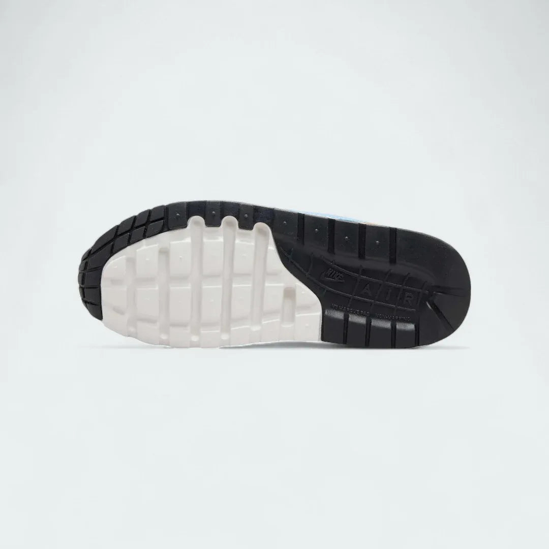 View of the outsole of the Nike Air Max 1 Juniors' brown trainers, showing the durable rubber waffle tread pattern.