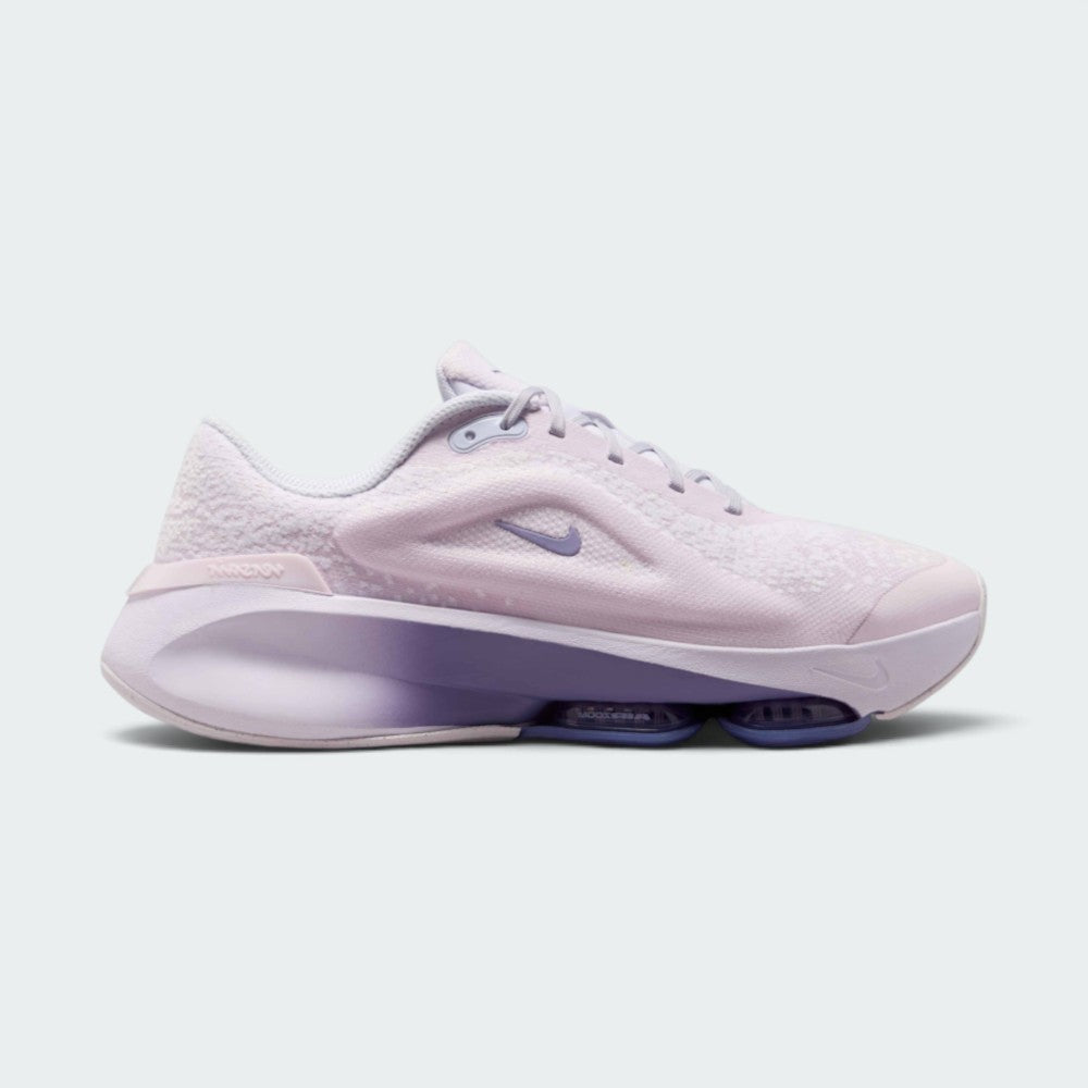 Highlights the lateral profile featuring a mini purple Nike Swoosh set into the plush Bleached Lilac chenille upper, a gradient Dusty Amethyst foam midsole wall, visible Zoom Air pod window, and a moulded heel clip. Main image