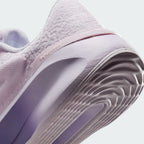 Highlights the "unreal" clean finish where the grooved lilac rubber sole meets the gradient foam midsole, framing the debossed "versair" heel clip.
