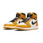 Angled view of two Air Jordan 1 Retro High OG Men's trainers in yellow, black, and sail, side by side, showcasing their iconic design and bold color blocking.