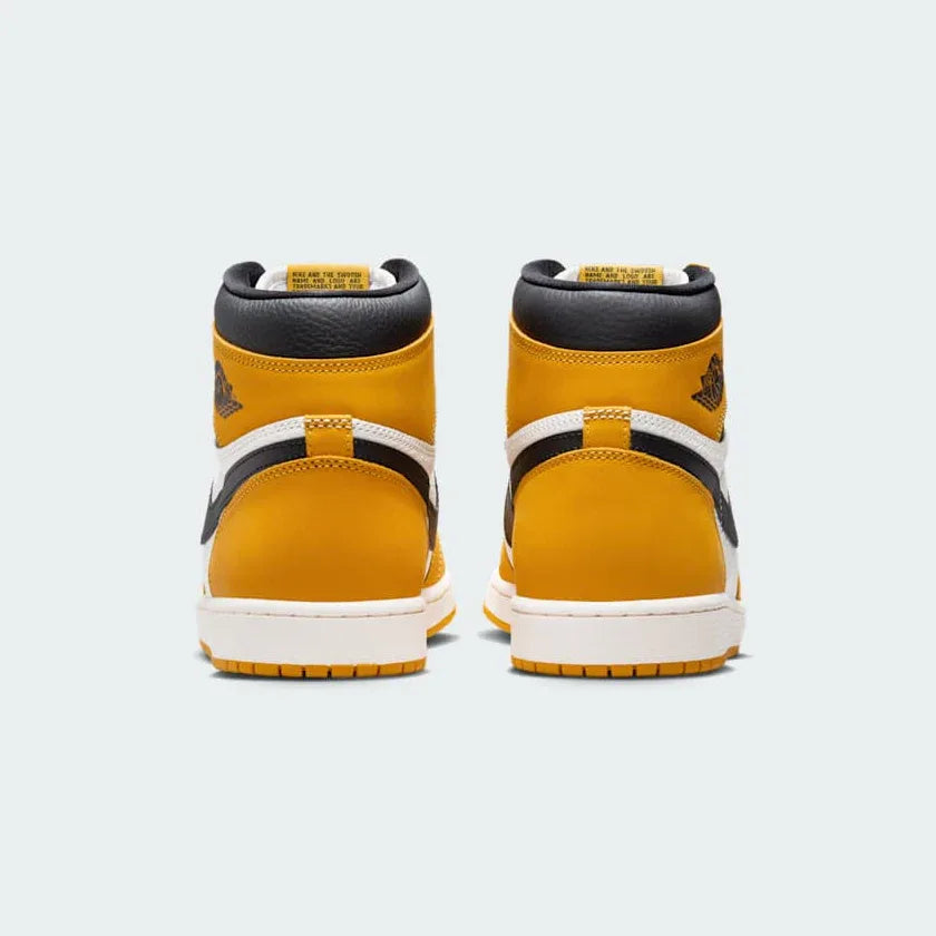 Rear view of the Air Jordan 1 Retro High OG Men's yellow trainers, focusing on the Wings logo on the ankle collar and contrasting heel panels.