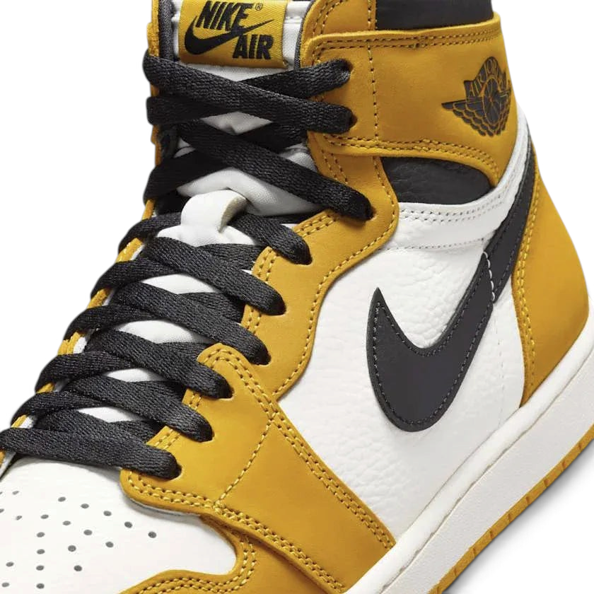 Close-up zoom on the front of the Air Jordan 1 Retro High OG Men's yellow trainers, showing the perforated toe box, lacing system, and textured leather upper.