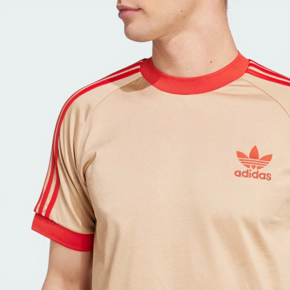 Zoom looking at the front of the shirt and the Trefoil, highlighting the precision of the embroidery and the fine jersey grain.