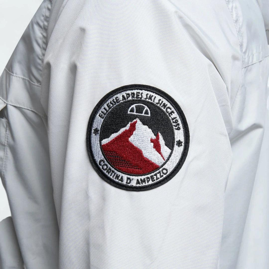 Close-up zoom on the fabric of the Ellesse Mont 2 Overhead Anorak Jacket, showing the textured marl finish and the embroidered or printed Ellesse logo.