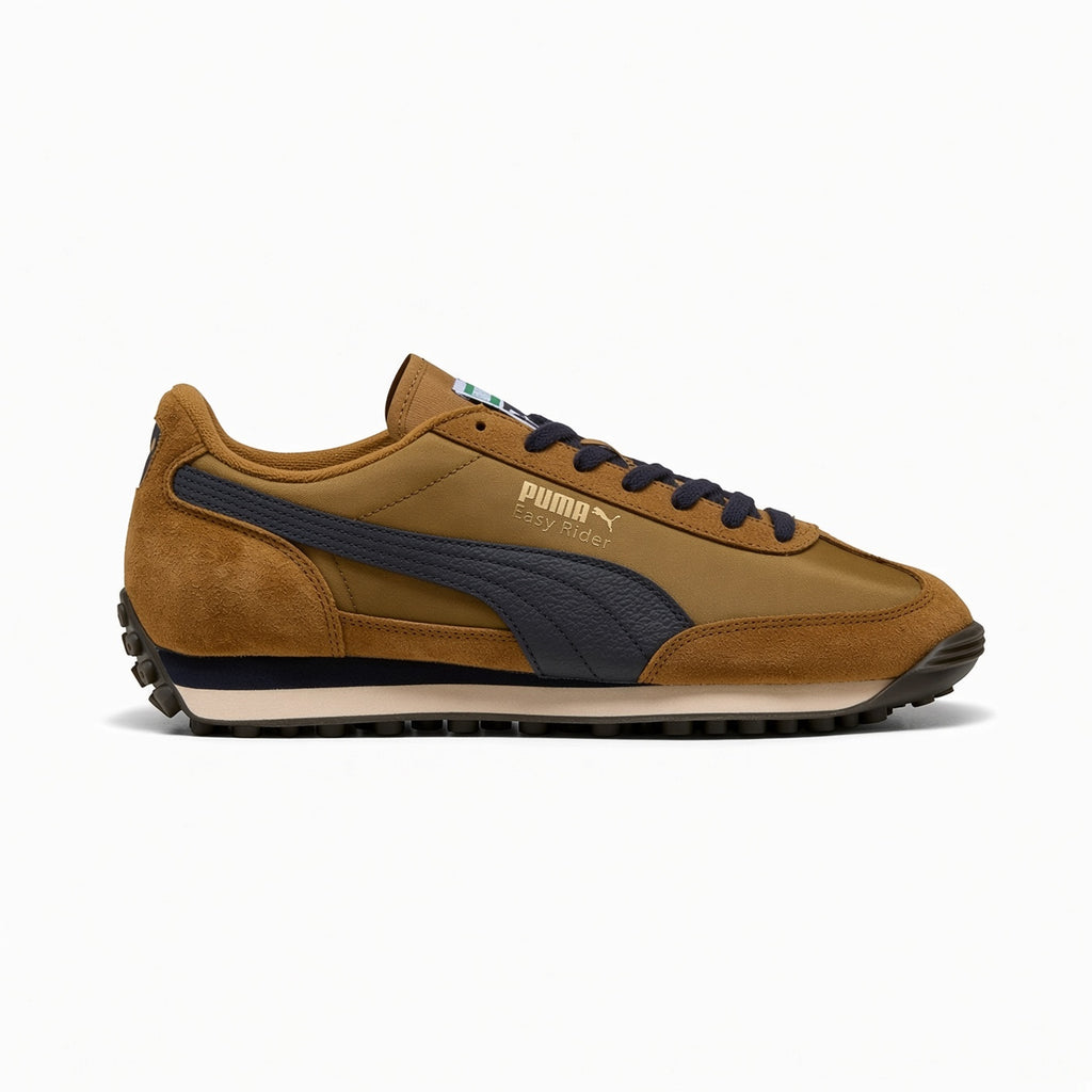 Highlights the slim-profile 1970s lateral silhouette showing the warm Honey Butter textile base, buttery suede toe and heel mudguards, prominent New Navy leather Formstrip, wedge-shaped dual-tone EVA midsole, and studded black rubber outsole.