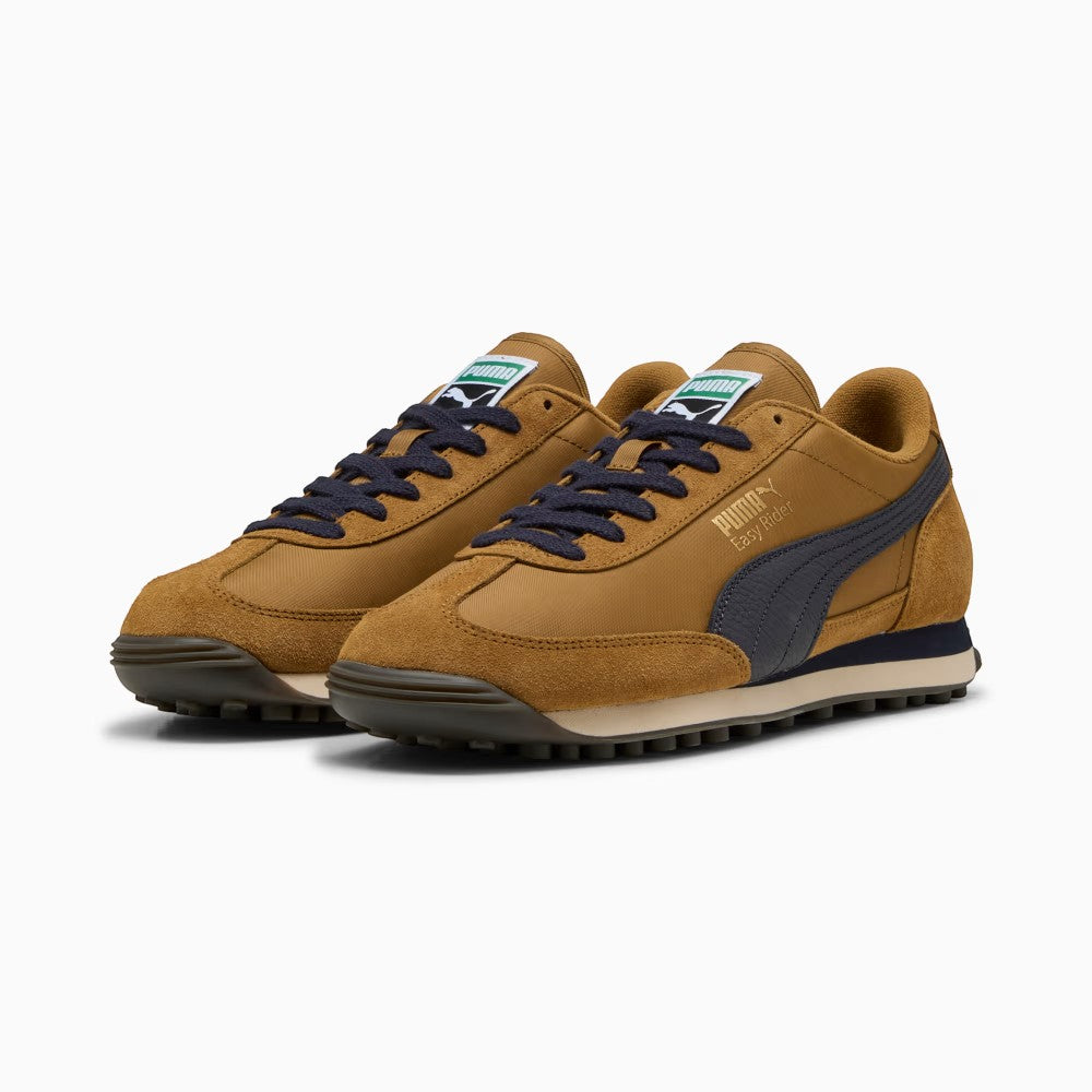 Forward three-quarter angle showcasing both shoes side by side, highlighting the retro slim-profile 1970s running silhouette, contrasting navy laces, suede mudguards, and the low-profile stance.