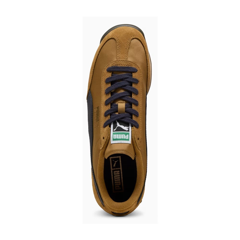 Overhead look at the shoe highlighting the Honey Butter textile vamp, reinforced suede T-toe mudguard, central lacing system with navy flat laces, retro green-trimmed PUMA woven tongue label, and brown cushioned insole with gold PUMA branding.